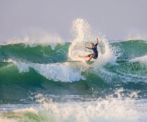 Senior surf coach Tim surfing